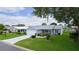 Exterior of home featuring a well-maintained lawn and driveway design at 1225 Zapata Pl, The Villages, FL 32159