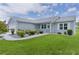 Exterior view of a cozy home with manicured front lawn and walkway at 1225 Zapata Pl, The Villages, FL 32159