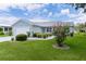 Charming single-story home with a well-manicured lawn and mature landscaping at 1225 Zapata Pl, The Villages, FL 32159