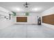 Spacious garage with overhead lighting, storage racks, and a clean epoxy floor at 1225 Zapata Pl, The Villages, FL 32159