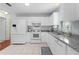 Bright kitchen features white appliances, tile flooring and granite countertops at 1225 Zapata Pl, The Villages, FL 32159