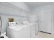 Functional laundry room featuring a washer, dryer, and extra storage at 1225 Zapata Pl, The Villages, FL 32159