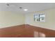 Bright, sunny living room featuring wood floors, a ceiling fan, and a window with blinds at 1225 Zapata Pl, The Villages, FL 32159