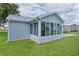 Back view of sunroom with lots of natural light and vinyl siding at 1225 Zapata Pl, The Villages, FL 32159