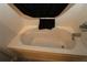 A combined bathtub and jacuzzi with white tiling and a black shower curtain at 1412 Forest Acres Dr, The Villages, FL 32162