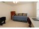 Bedroom with a white daybed, desk, and wood dresser with natural light at 1412 Forest Acres Dr, The Villages, FL 32162