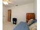 Bedroom with white daybed, dresser, and open door at 1412 Forest Acres Dr, The Villages, FL 32162