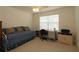 Bedroom with a white daybed, desk, chair and large window with blinds at 1412 Forest Acres Dr, The Villages, FL 32162