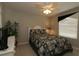 A bedroom with a queen size bed, ceiling fan, neutral colors and a plant at 1412 Forest Acres Dr, The Villages, FL 32162