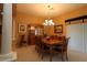 Traditional dining room features a wooden table, elegant chandelier, and decorative cabinet at 1412 Forest Acres Dr, The Villages, FL 32162
