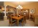 An elegant dining room features a chandelier and is conveniently located next to the kitchen at 1412 Forest Acres Dr, The Villages, FL 32162