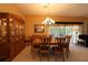 Dining room with wooden furniture and sliding glass doors to the backyard at 1412 Forest Acres Dr, The Villages, FL 32162