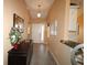 Inviting foyer with neutral colors, decorative mirror, pendant lighting, and a view of the front door at 1412 Forest Acres Dr, The Villages, FL 32162