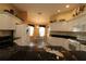 Bright eat-in kitchen with white cabinets, granite countertops, and a view of the dining area at 1412 Forest Acres Dr, The Villages, FL 32162