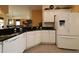 Spacious kitchen featuring white cabinets, dark granite countertops, and modern appliances at 1412 Forest Acres Dr, The Villages, FL 32162