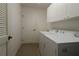 Functional laundry room with white cabinets, a utility sink, and a washer/dryer at 1412 Forest Acres Dr, The Villages, FL 32162