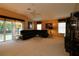 Spacious living room with a fan, sliding glass doors, and stylish decor at 1412 Forest Acres Dr, The Villages, FL 32162