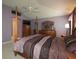 Spacious main bedroom with a four-poster bed, dual dressers, and a calming color scheme at 1412 Forest Acres Dr, The Villages, FL 32162