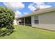 A nice angle of the patio with exterior siding and beautiful landscaping, shrubs and trees at 1412 Forest Acres Dr, The Villages, FL 32162