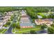 Scenic aerial view of a residential neighborhood with lush landscaping, a pond, and well-maintained homes at 167 Castaway Beach Way, Kissimmee, FL 34746