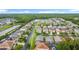 Expansive aerial shot of a suburban community featuring tree-lined streets, lakes, and various home styles at 167 Castaway Beach Way, Kissimmee, FL 34746