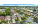 Aerial view of neighborhood homes, mature trees, a pond, and a cul-de-sac at 167 Castaway Beach Way, Kissimmee, FL 34746