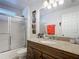 Well-maintained bathroom with granite vanity top, shower-tub combination, and modern fixtures at 167 Castaway Beach Way, Kissimmee, FL 34746