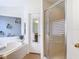 Bright bathroom features a shower with glass doors and a soaker tub at 167 Castaway Beach Way, Kissimmee, FL 34746