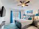 The bedroom has a ceiling fan and is brightly lit with a queen bed and balcony access at 167 Castaway Beach Way, Kissimmee, FL 34746