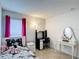 Furnished bedroom with a full-size bed, vanity, and desk, offering a functional living space at 167 Castaway Beach Way, Kissimmee, FL 34746