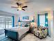 Bright bedroom with beach themed decor, a ceiling fan, and a comfy sitting chair at 167 Castaway Beach Way, Kissimmee, FL 34746