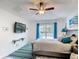 This bedroom features a queen bed, ceiling fan, and access to an outdoor area at 167 Castaway Beach Way, Kissimmee, FL 34746