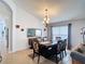 Open-concept dining room with a modern chandelier and stylish furniture at 167 Castaway Beach Way, Kissimmee, FL 34746