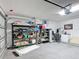 Messy Garage with shelving, storage items, fan, and mini fridge for extra space at 167 Castaway Beach Way, Kissimmee, FL 34746