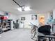 Cluttered garage space with a grill, bike, storage, fan, and a mini fridge at 167 Castaway Beach Way, Kissimmee, FL 34746