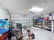 Spacious garage with ample storage, bikes, and a grill, offering plenty of room for vehicles and hobbies at 167 Castaway Beach Way, Kissimmee, FL 34746