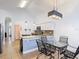 Bright kitchen with stainless steel appliances, granite countertops, and open dining area at 167 Castaway Beach Way, Kissimmee, FL 34746