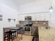 Well-lit kitchen equipped with stainless steel appliances, granite countertops, and ample storage at 167 Castaway Beach Way, Kissimmee, FL 34746