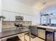 Modern kitchen boasting stainless steel appliances, granite countertops, and white cabinetry at 167 Castaway Beach Way, Kissimmee, FL 34746