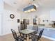 Bright eat-in kitchen features granite countertops, stainless steel appliances, and stylish lighting at 167 Castaway Beach Way, Kissimmee, FL 34746