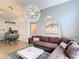 Spacious living room featuring modern lighting, comfortable seating, and a view of the kitchen at 167 Castaway Beach Way, Kissimmee, FL 34746