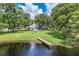 Aerial view of home with lake access, mature trees, and a private dock at 168 Pond Rd, Mount Dora, FL 32757