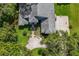 An aerial view showcases the home's roof, driveway, entrance, and lush surrounding landscape at 168 Pond Rd, Mount Dora, FL 32757