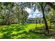 A picturesque backyard offers a serene waterfront view and ample space for outdoor enjoyment at 168 Pond Rd, Mount Dora, FL 32757