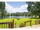 Lush backyard with serene lake view, private dock, and a wooden deck perfect for enjoying nature at 168 Pond Rd, Mount Dora, FL 32757