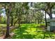 The property boasts a spacious backyard with lush greenery, mature trees, and tranquil water views at 168 Pond Rd, Mount Dora, FL 32757