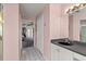 Bright bathroom featuring a single sink vanity and doorway leading into bedroom at 168 Pond Rd, Mount Dora, FL 32757
