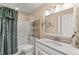 Full bathroom with marble sink, large vanity mirror and floral shower curtain at 168 Pond Rd, Mount Dora, FL 32757