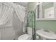 Cozy bathroom with shower, toilet and sink with decorative storage shelves at 168 Pond Rd, Mount Dora, FL 32757