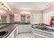 Elegant bathroom featuring a large tub, vanity with double sinks, and a window at 168 Pond Rd, Mount Dora, FL 32757